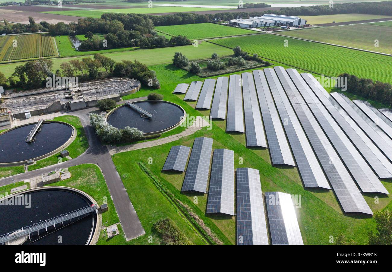 Aerial view of a wastewater treatment plant featuring large circular ...