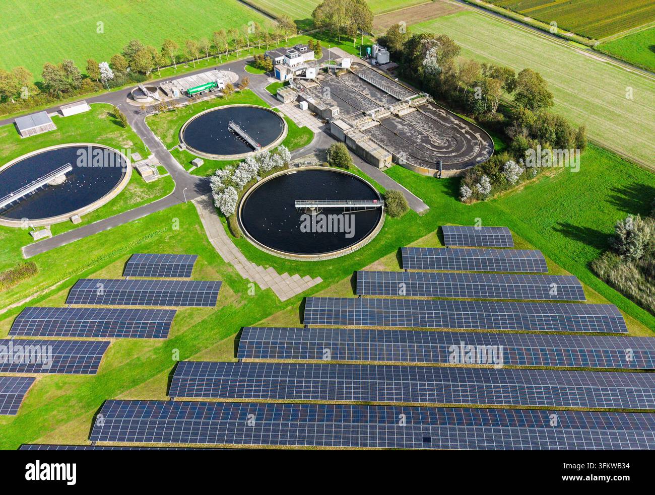 Aerial view of a wastewater treatment plant featuring circular ...