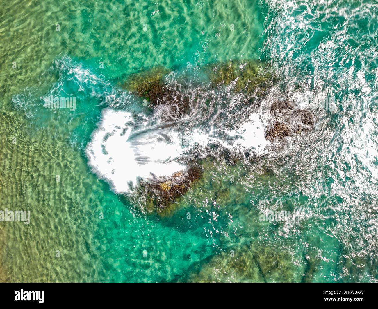 Aerial View Rocks Aerial view of Cudgen Headland South Head surrounded by turquoise ocean ...