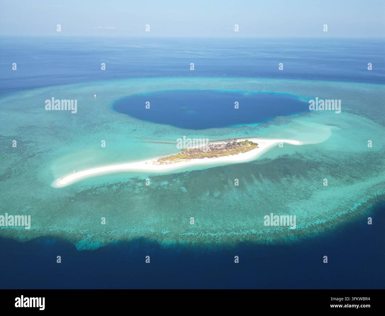 Aerial view of Pulau Ndaa, a small island with a white sand beach ...