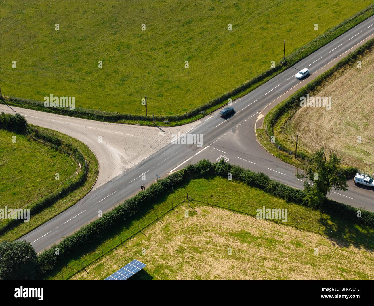 Aerial view of Lisburn Solar Farm surrounded by green fields and a road ...