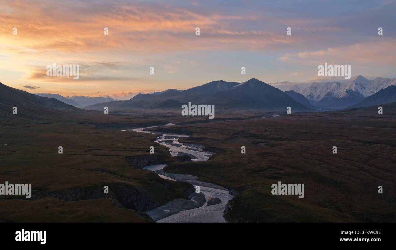 Aerial view of the winding river flowing through the vast landscape ...