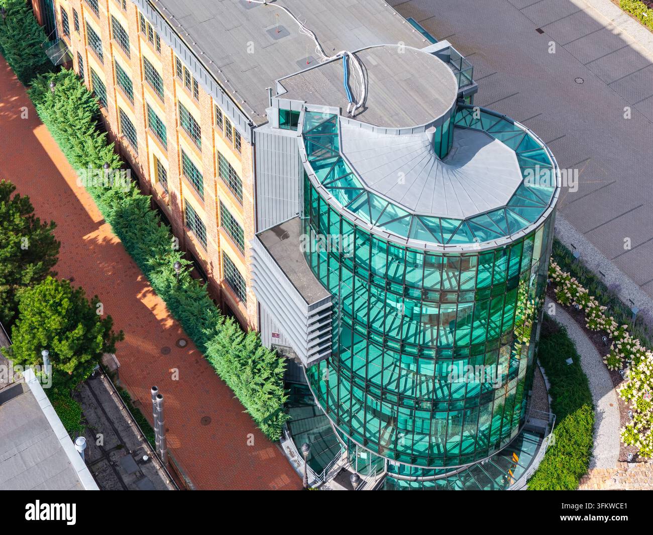 Aerial view of a modern glass-fronted building with a curved facade ...