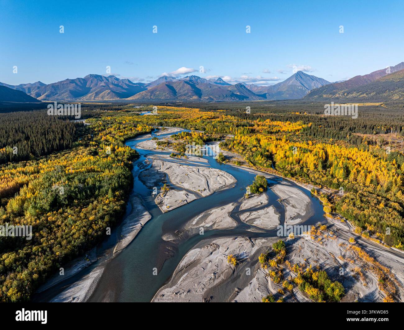 Aerial view of Tok River winding through a landscape of autumn-colored ...