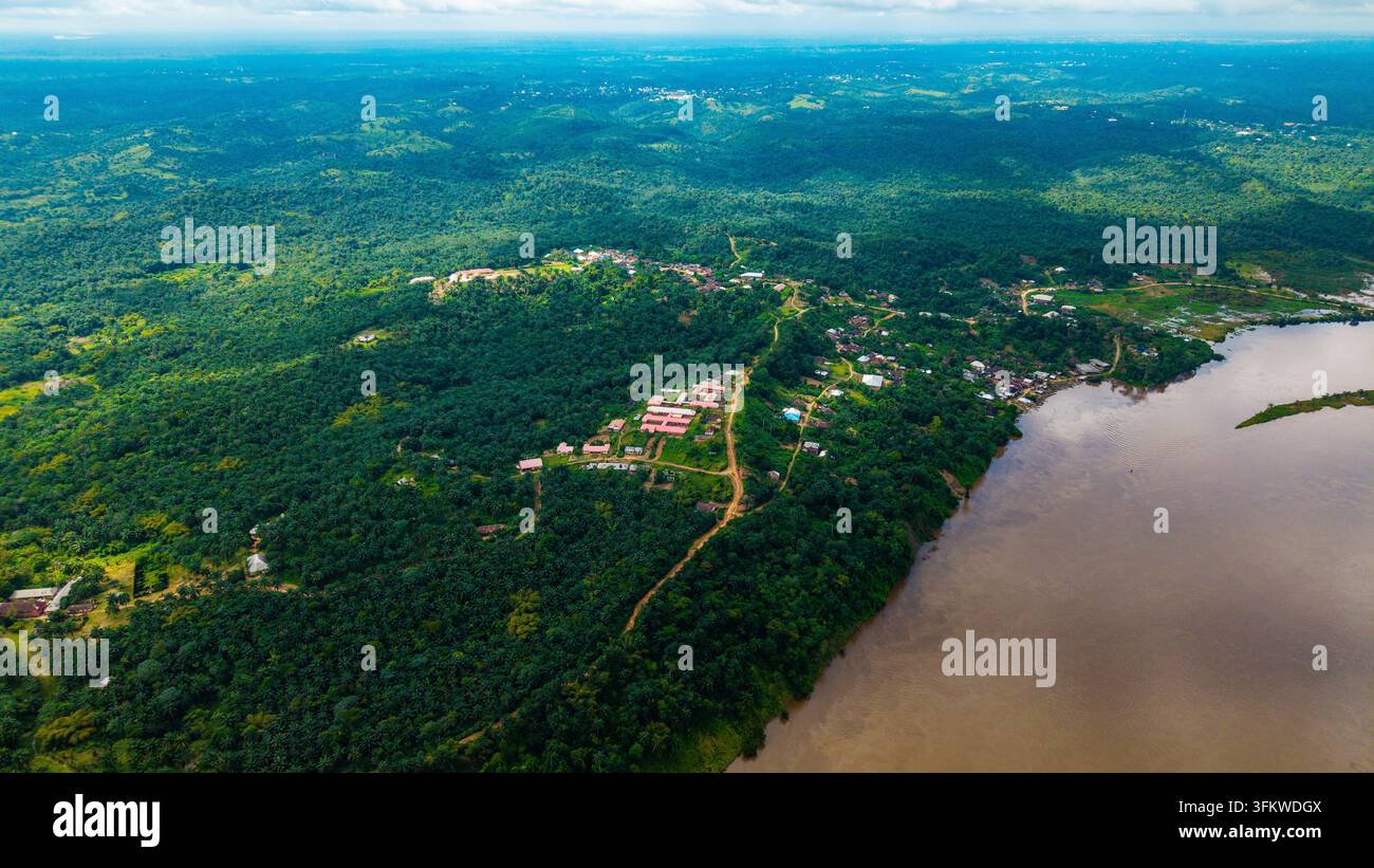 Aerial view of the lush green landscape and winding river flowing past ...