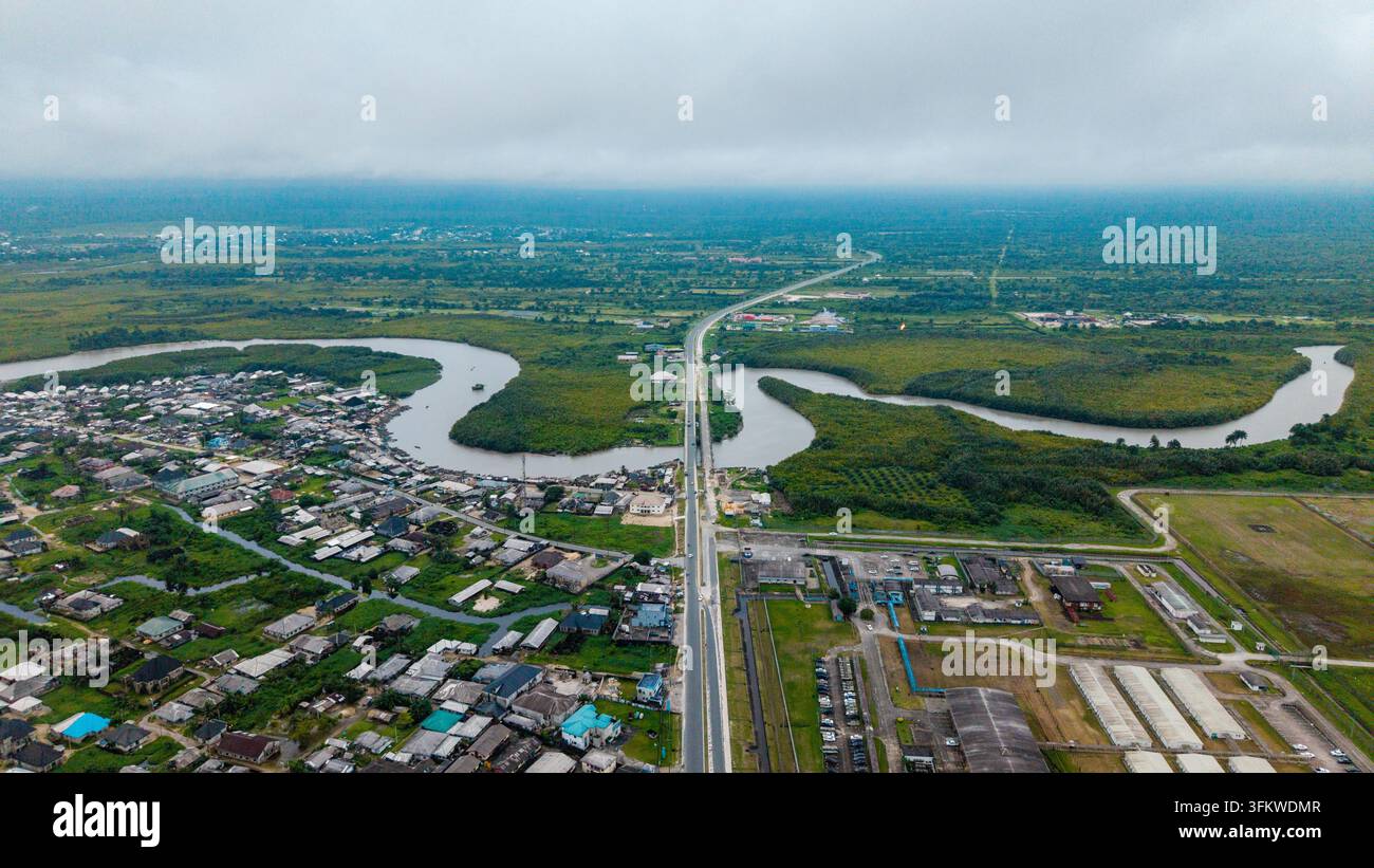 Aerial view of the winding Kwa Ibo River flowing through lush green ...