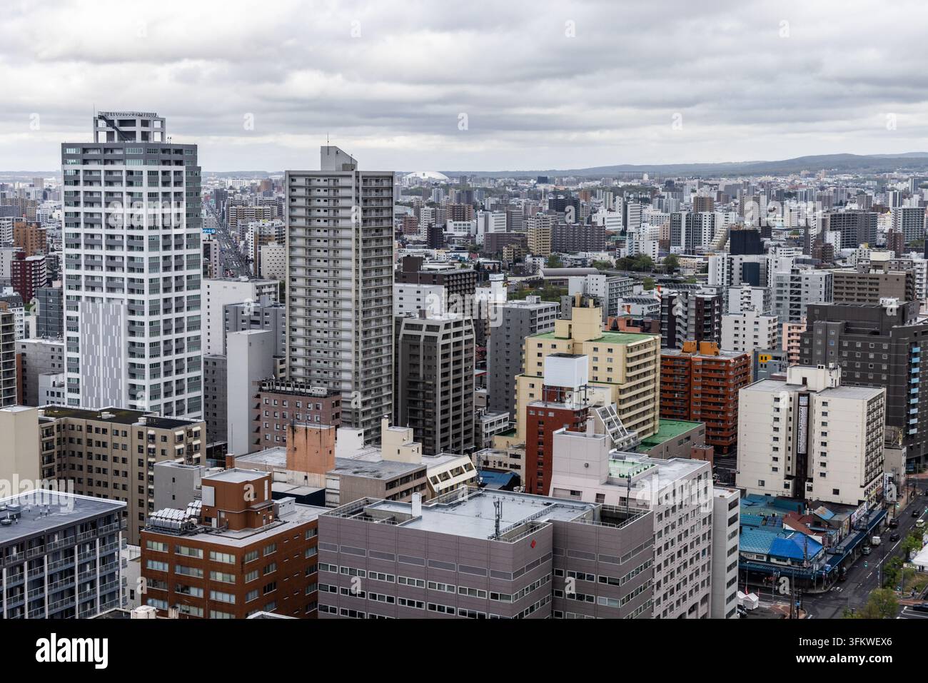 Aerial view of Sapporo city skyline featuring dense high-rise ...