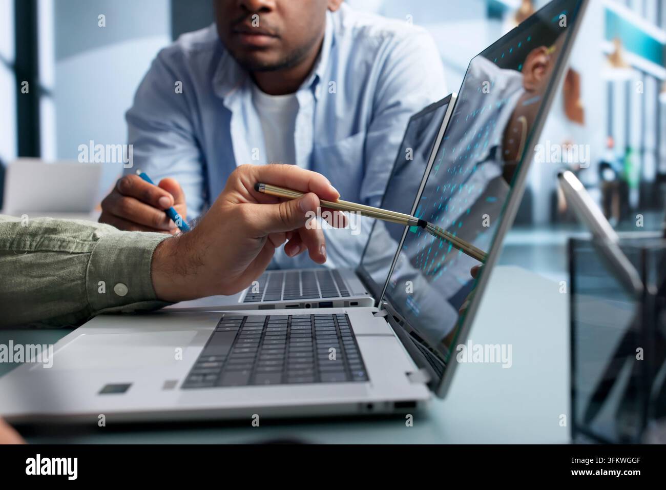 Data Scientist And Engineer Discuss AI Software Development Using Laptops. Stock Photo