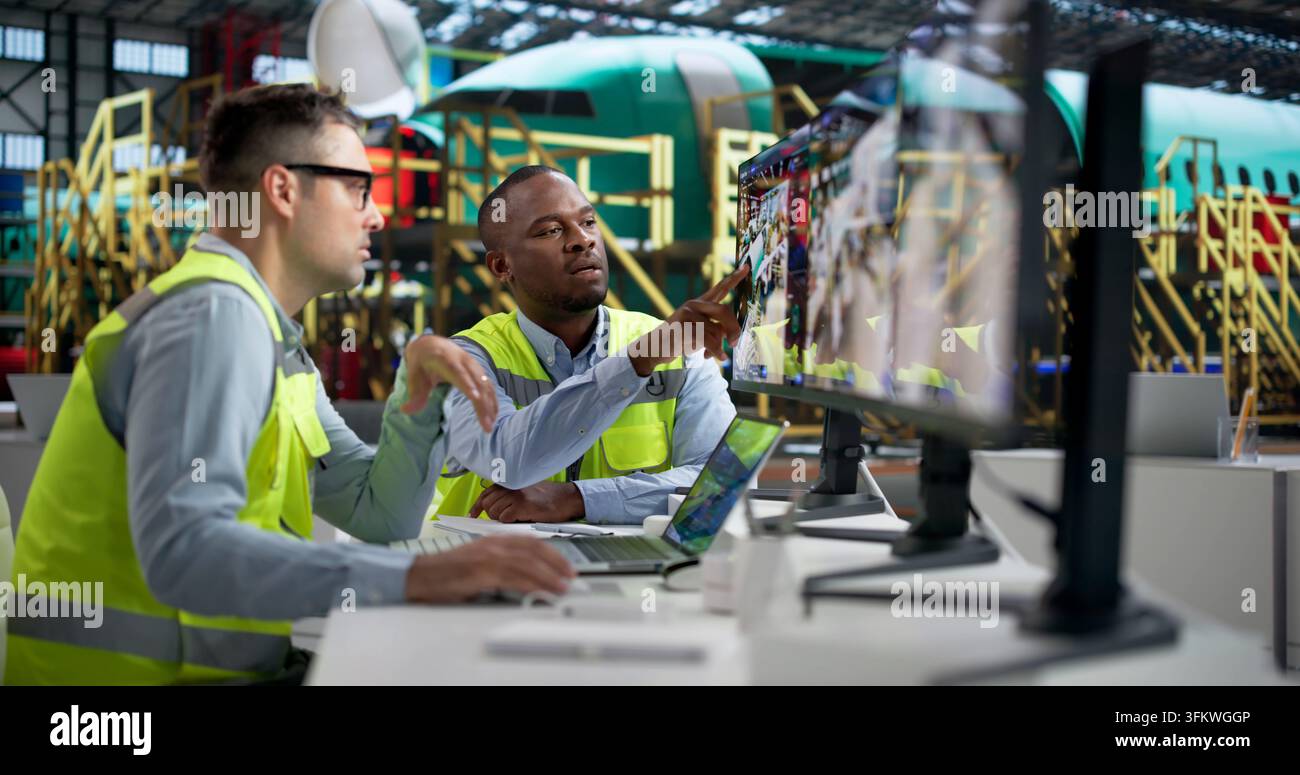 Engineer Closely Monitors Real-time Aircraft Data Using Advanced SCADA Software. Stock Photo