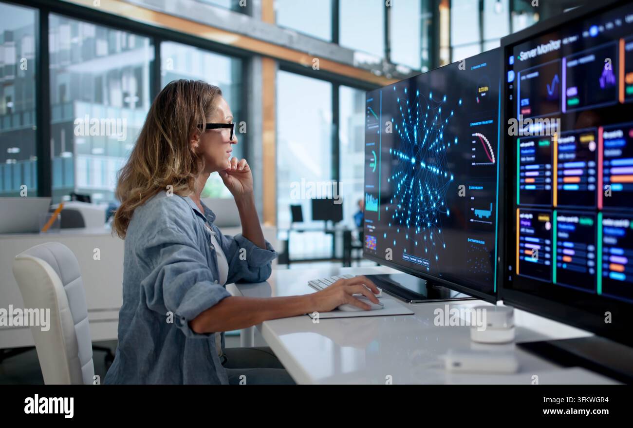 Data Scientist Carefully Analyzes Neural Network Models Using Advanced Software Tools At Workplace. Stock Photo