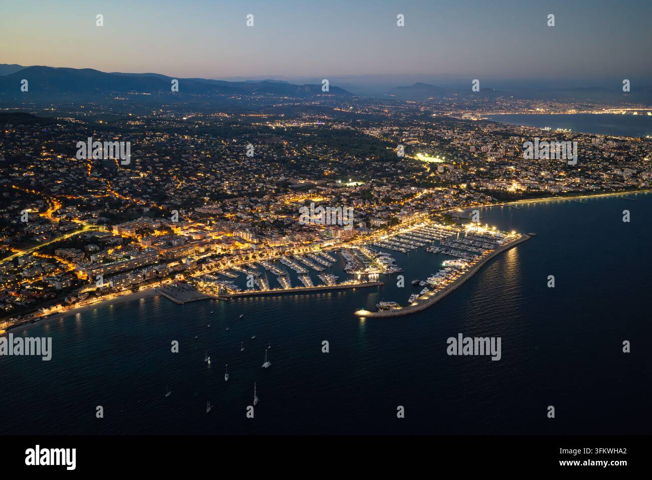 Aerial view of the illuminated marina and city lights of Antibes at ...