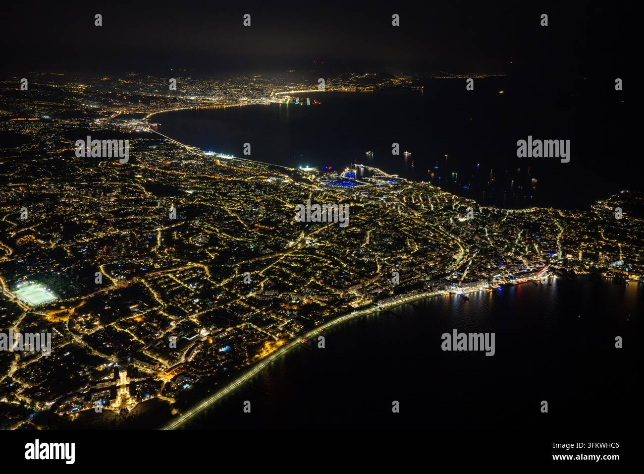 Aerial view of the illuminated coastline and city lights of Antibes at ...
