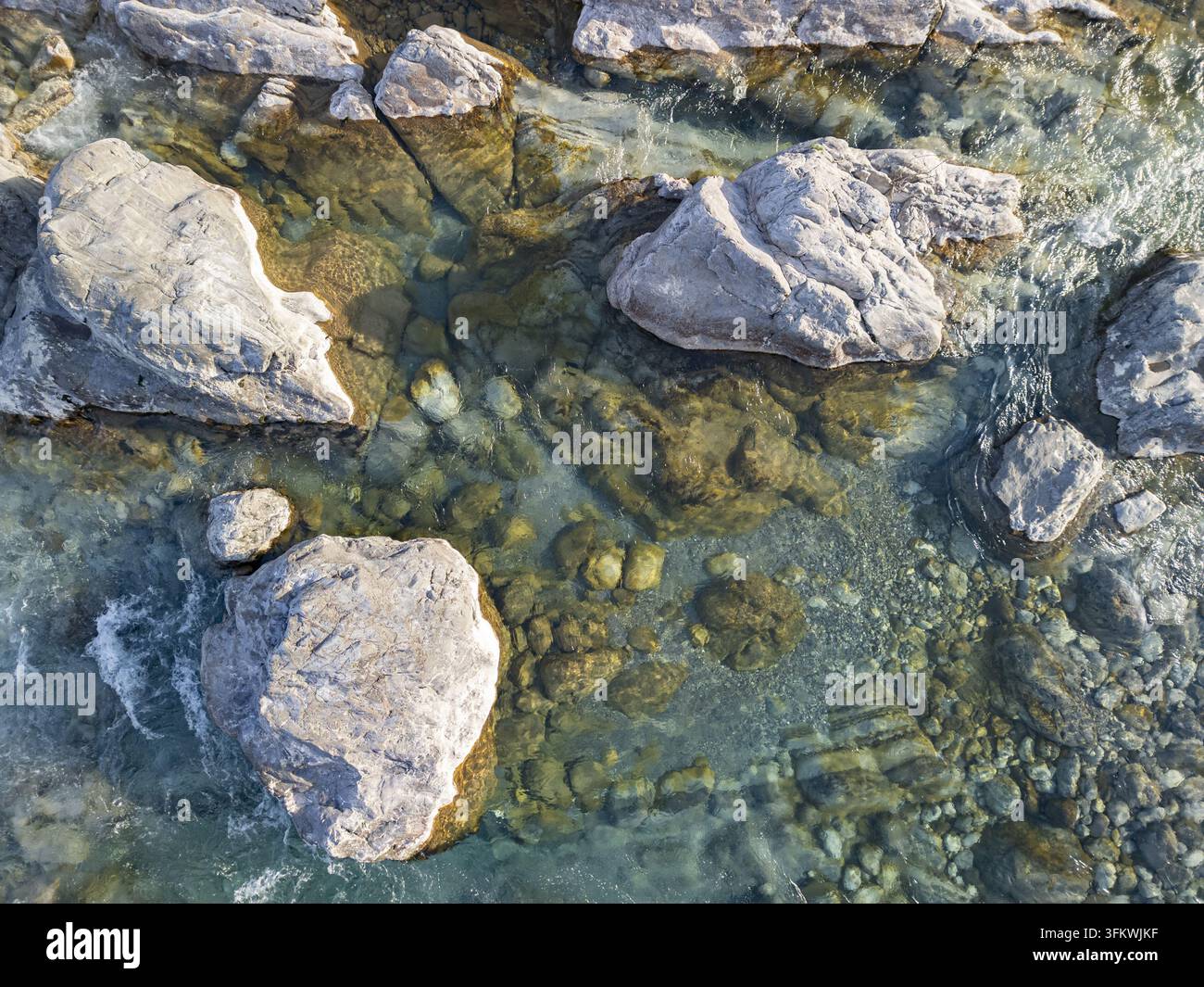 Aerial view of the clear waters of the Kiri River flowing over large ...