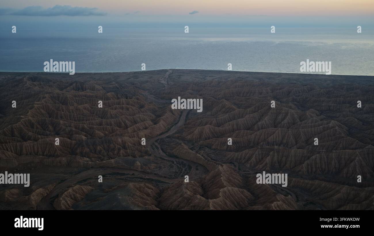 Aerial view of the rugged, arid landscape of Issyk Kul leading to the ...