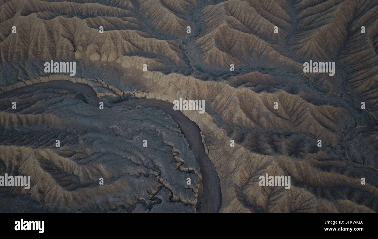 Aerial view of the winding river flowing through the rugged, arid ...