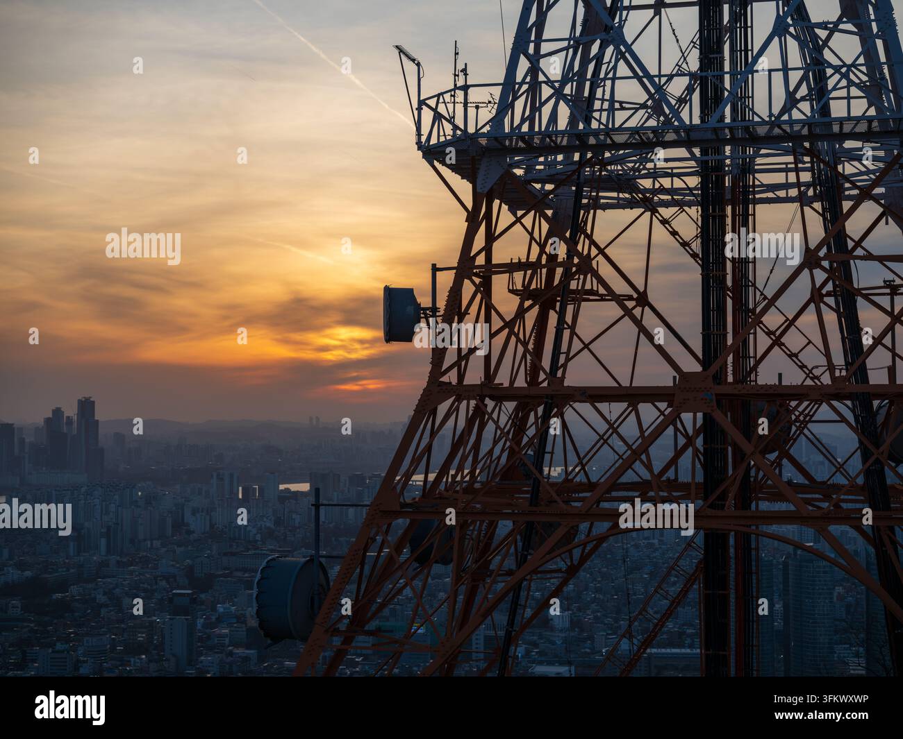 Aerial view of a telecommunications tower overlooking the city skyline ...