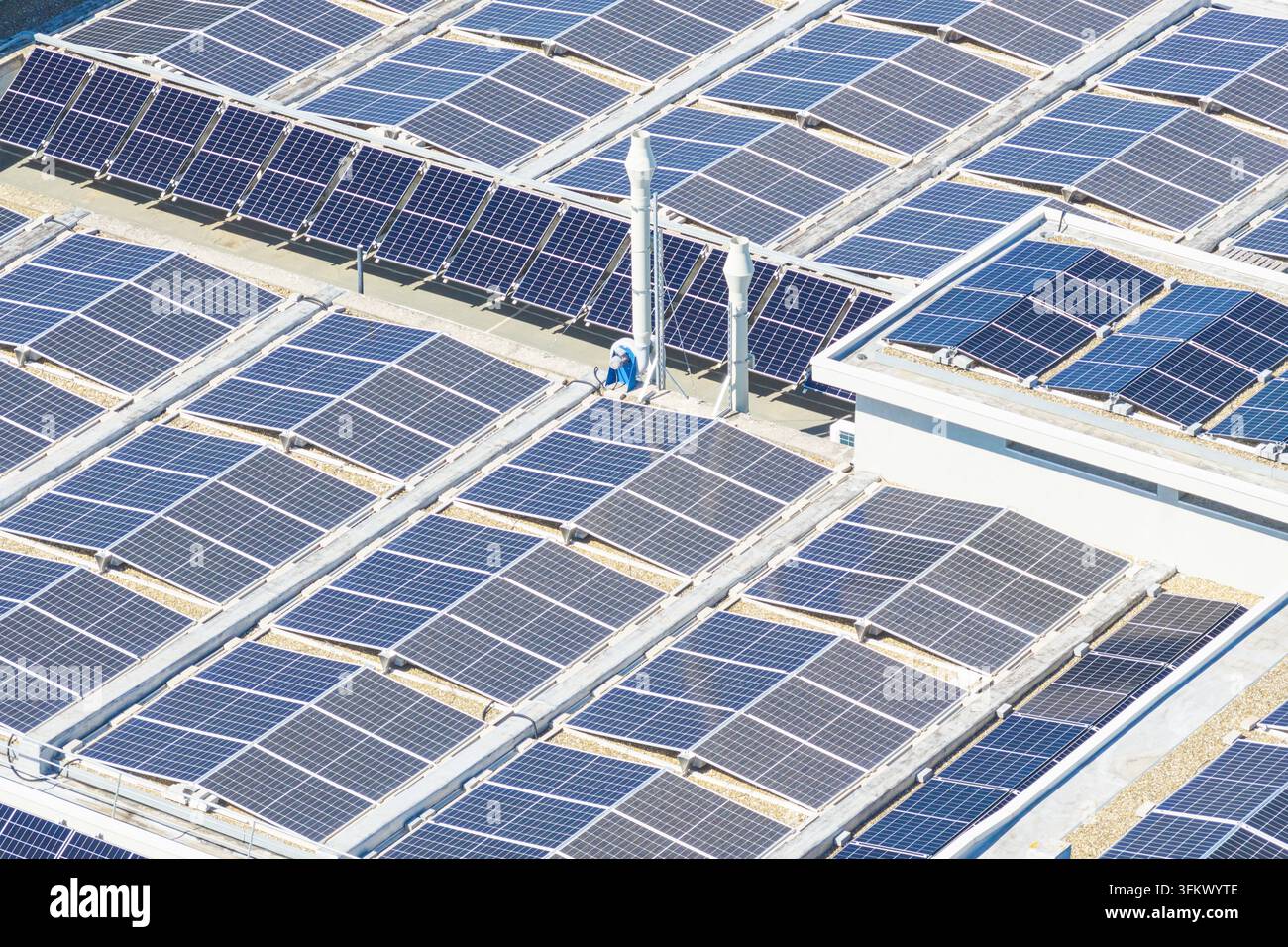 Aerial view of a large array of solar panels installed on a flat ...