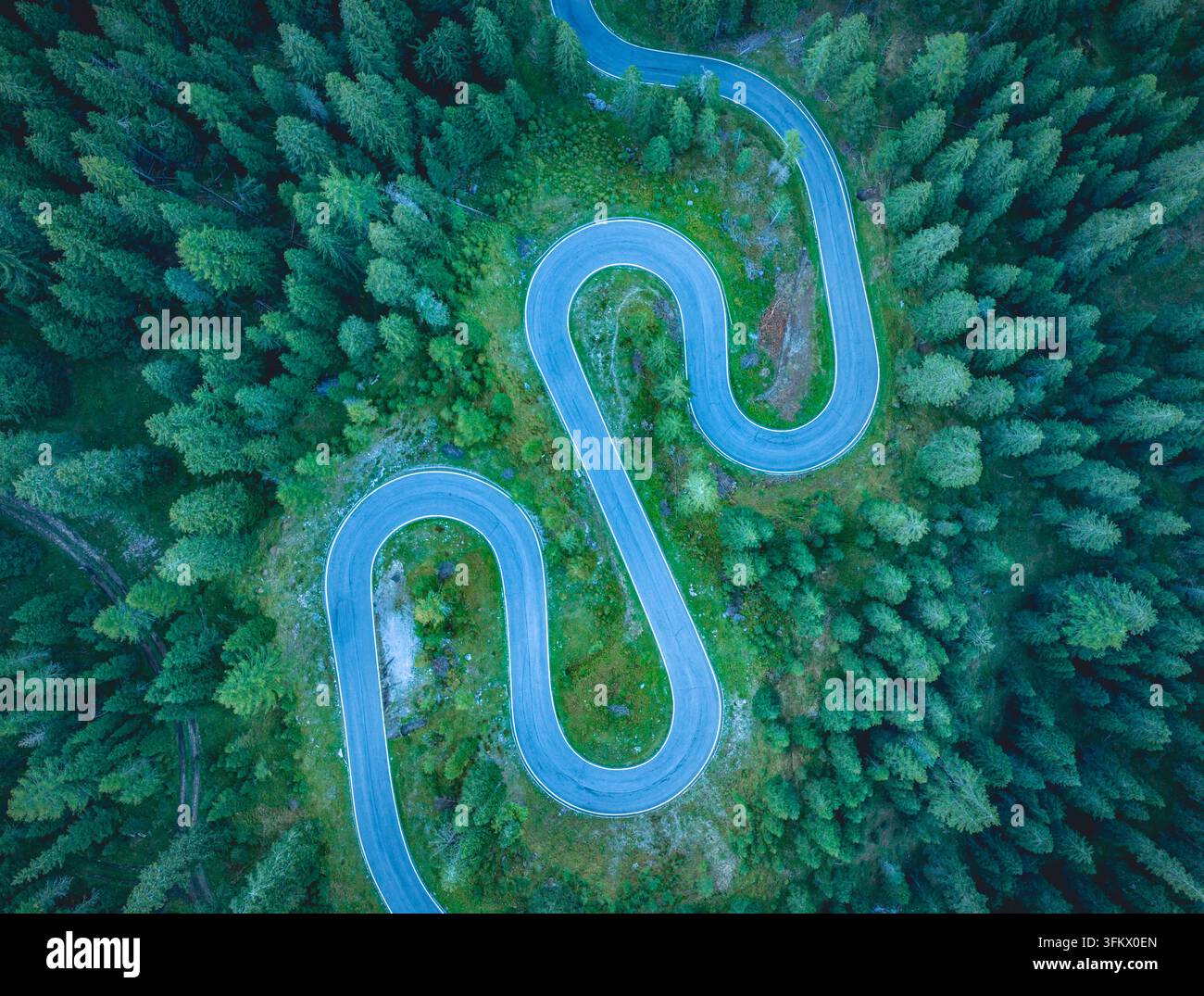 Aerial view of a winding mountain road with sharp hairpin bends ...