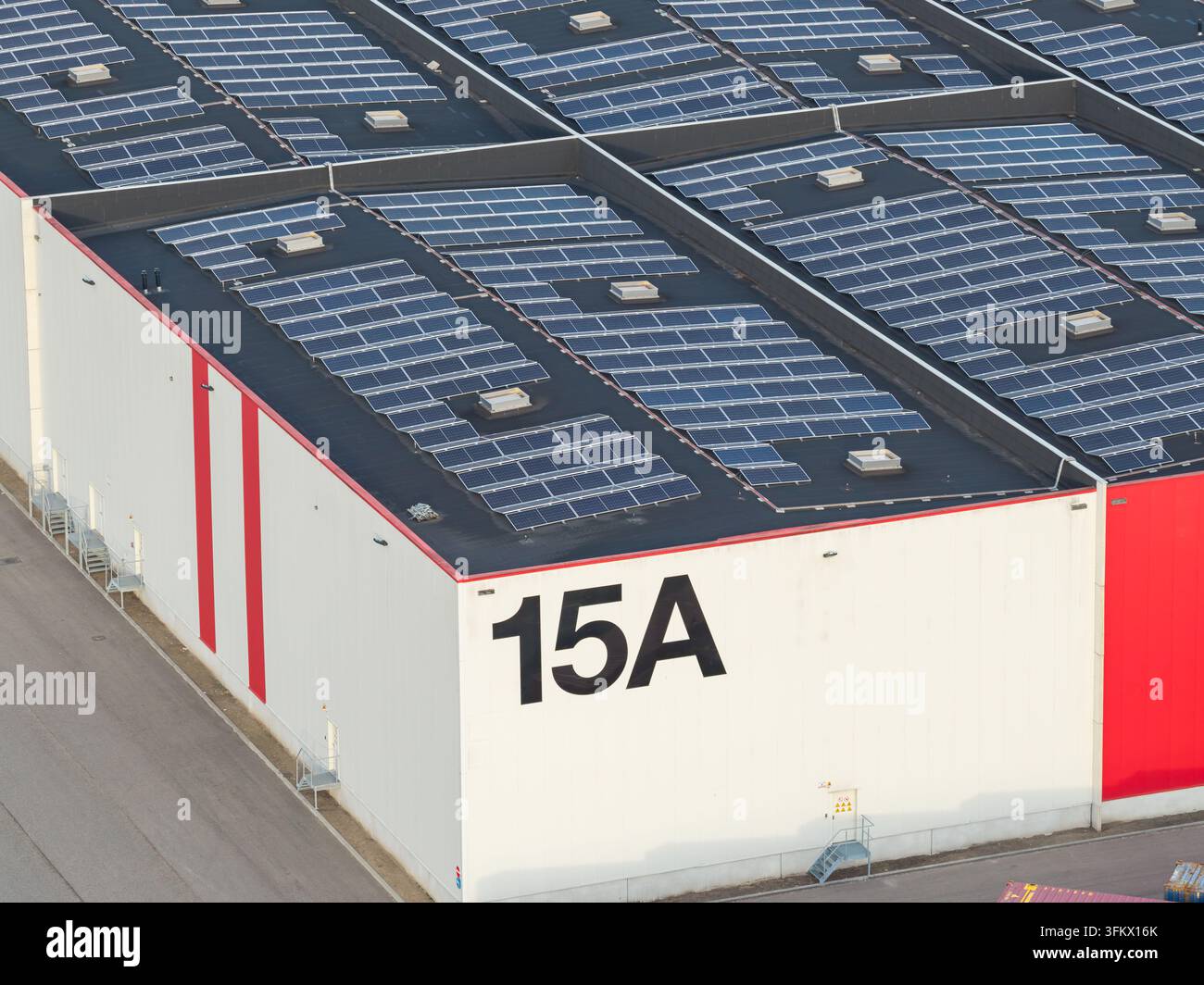 Aerial view of a large industrial warehouse roof covered with extensive ...