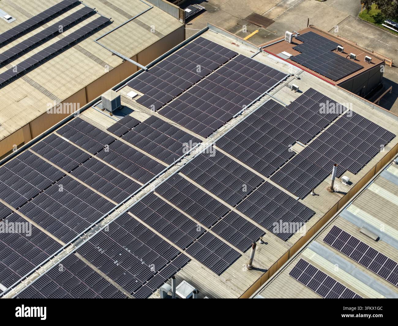 Aerial view of extensive solar panel arrays installed on the flat ...
