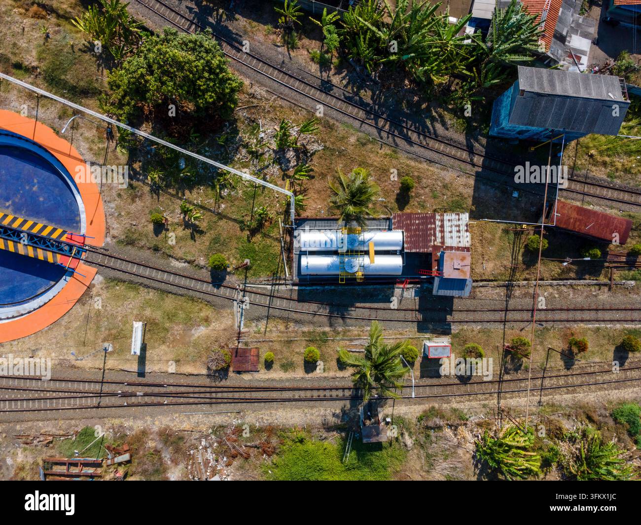 Aerial view of a railway turntable and storage tanks located near train ...