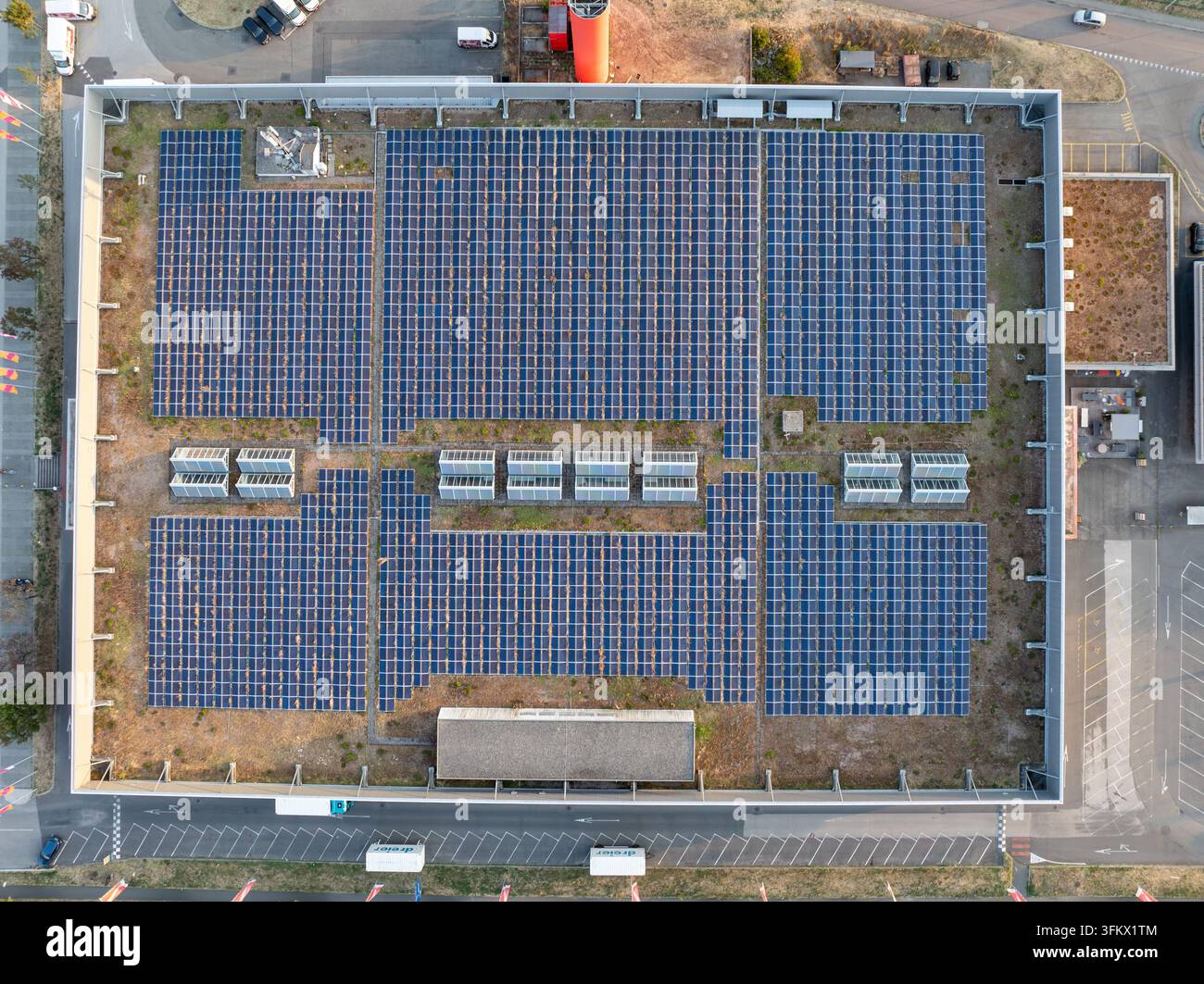 Aerial view of a large solar panel array installed on a green roof of a ...