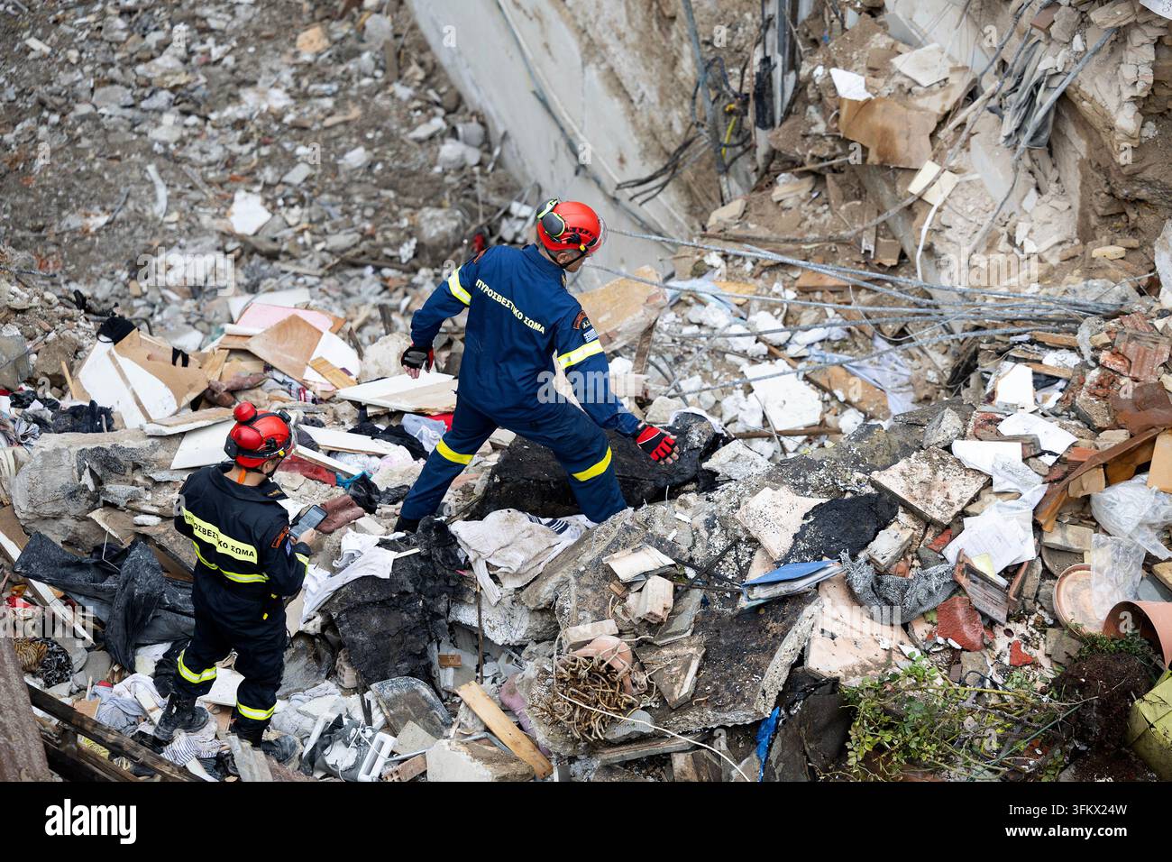 Firefighters work at the scene following Friday's powerful blast in ...
