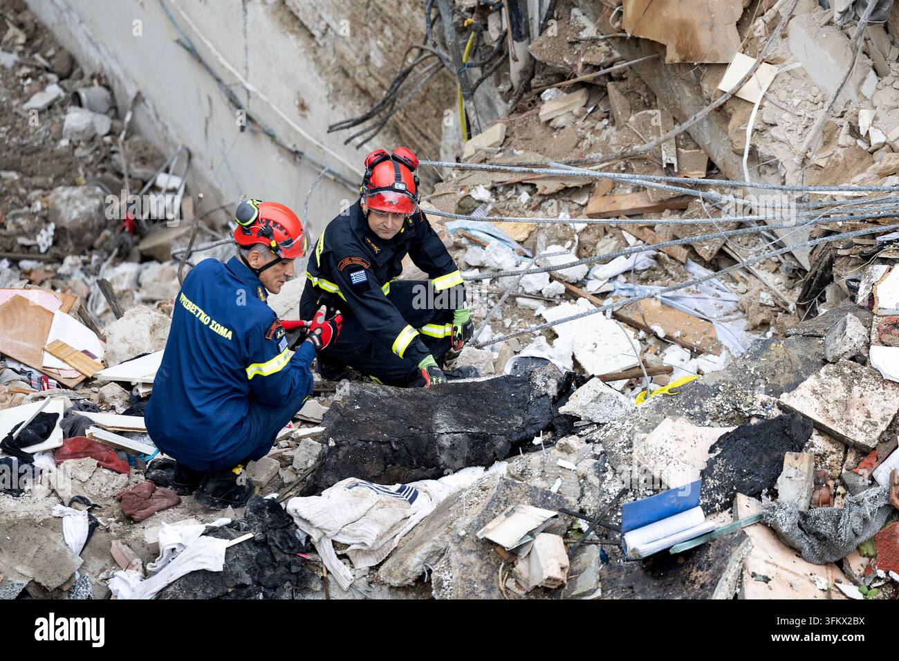 Firefighters work at the scene following Friday's powerful blast in ...