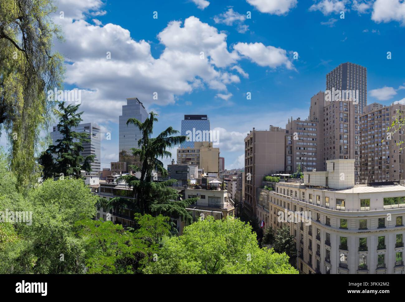 Aerial view of the modern cityscape of Santiago with lush green trees ...