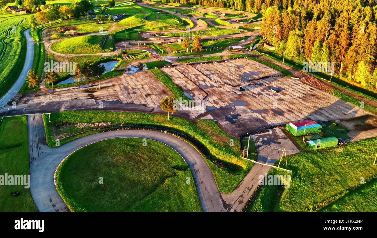 Aerial view of a go-kart racing track surrounded by lush green fields ...