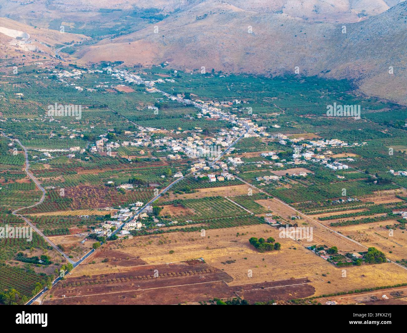 Aerial view of a small town nestled in the rural landscape of Sicily ...