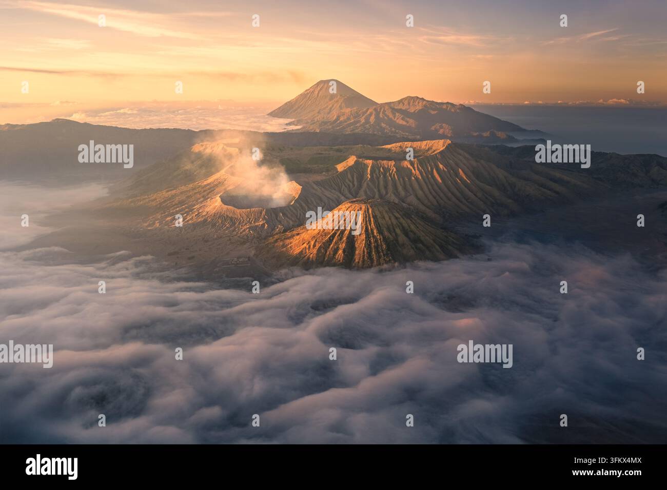 Aerial view of Mount Bromo with its volcanic crater emitting smoke ...