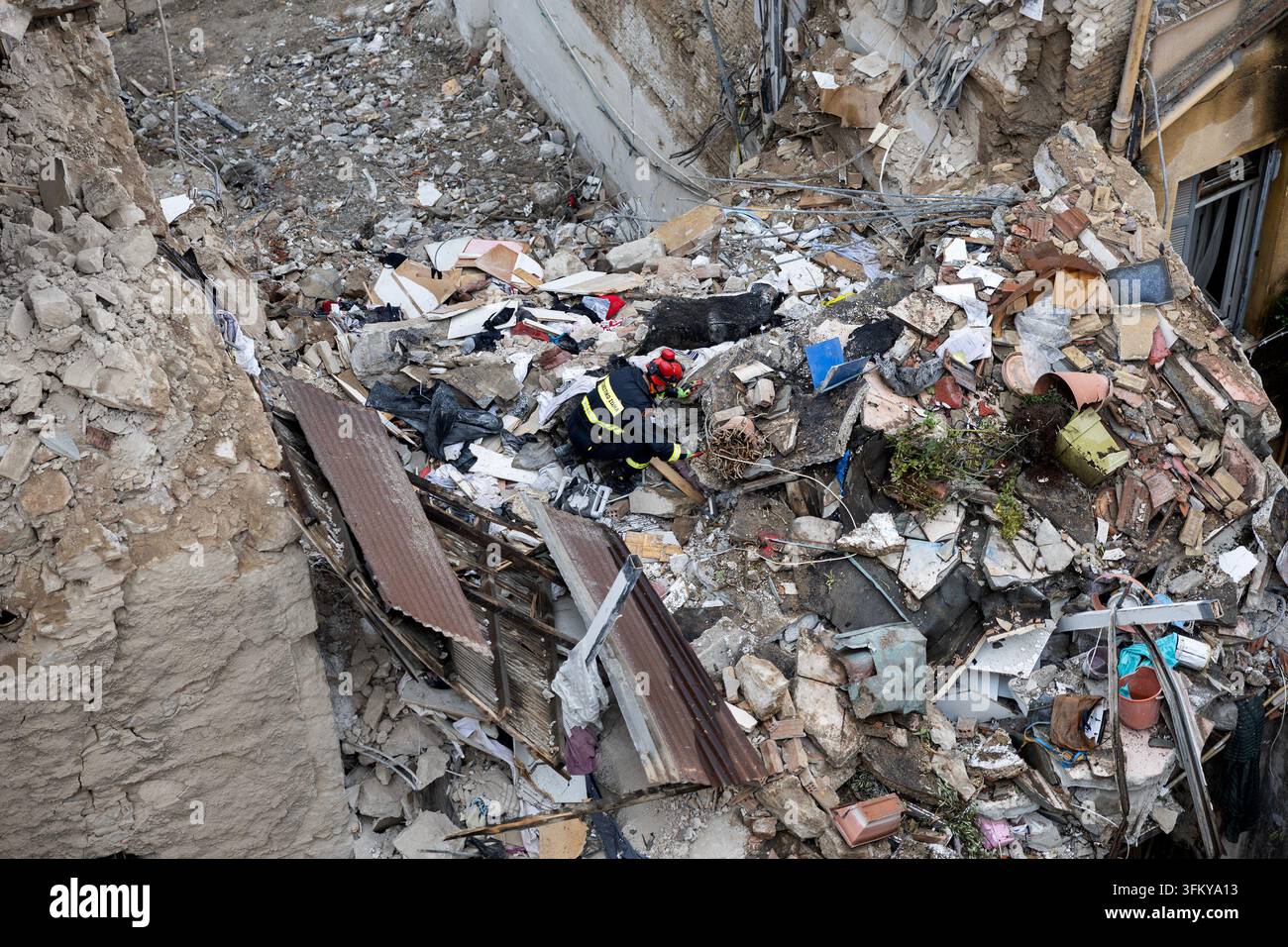 A rescuer works at the scene following Friday's powerful blast in ...