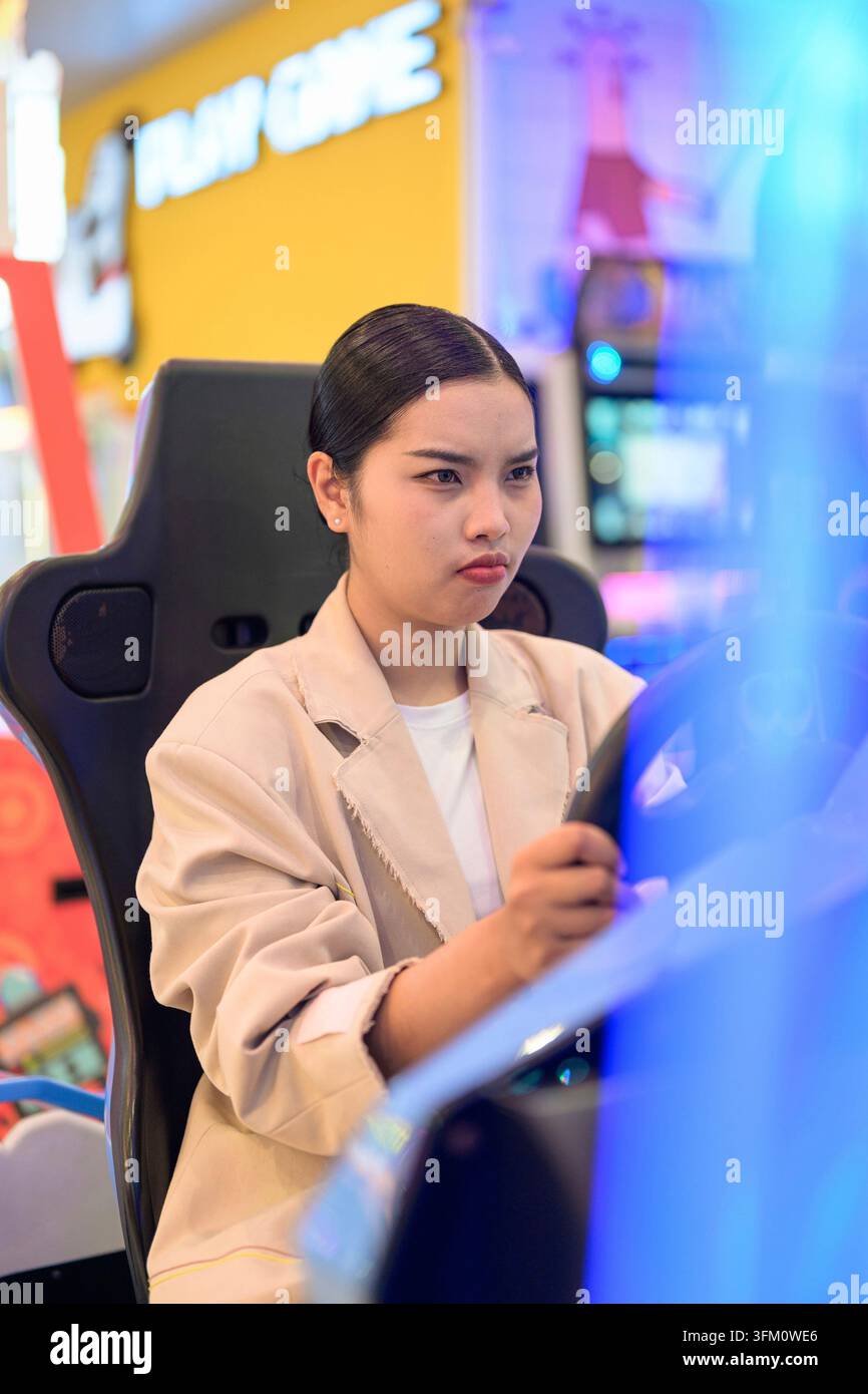 A professional front-angle portrait of an intense young Southeast Asian Thai businesswoman from the Isan region looking forward with concentration whi Stock Photo