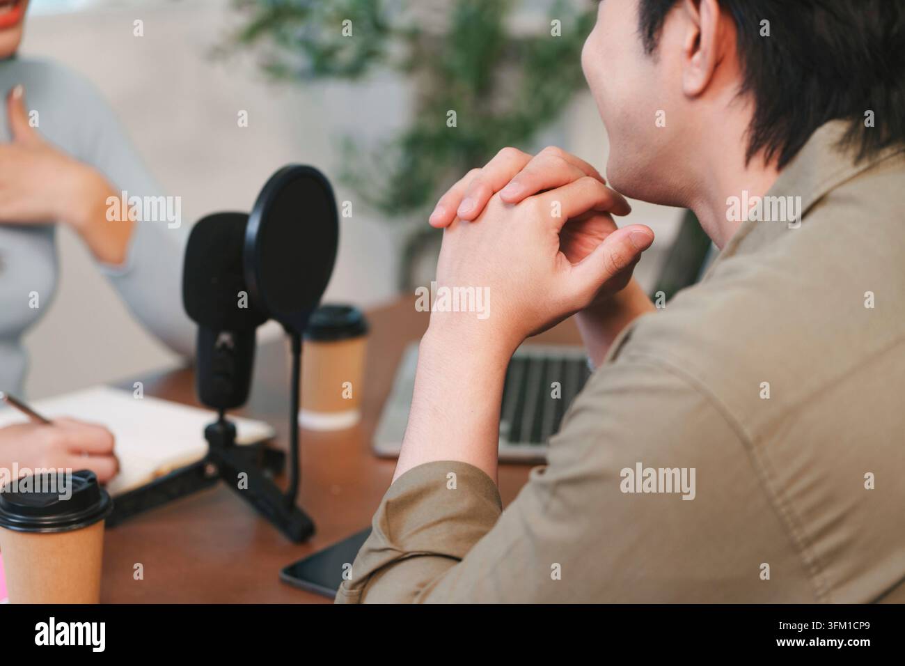 Woman clasped hands speaking hi-res stock photography and images - Alamy