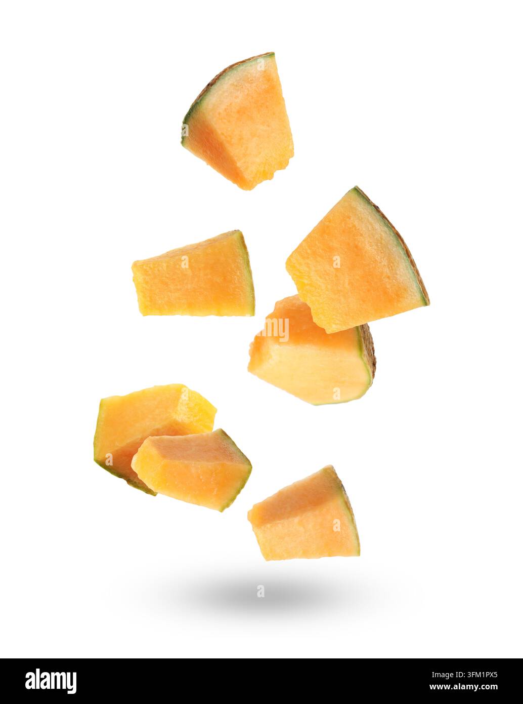 Pieces of cantaloupe melon falling on white background Stock Photo