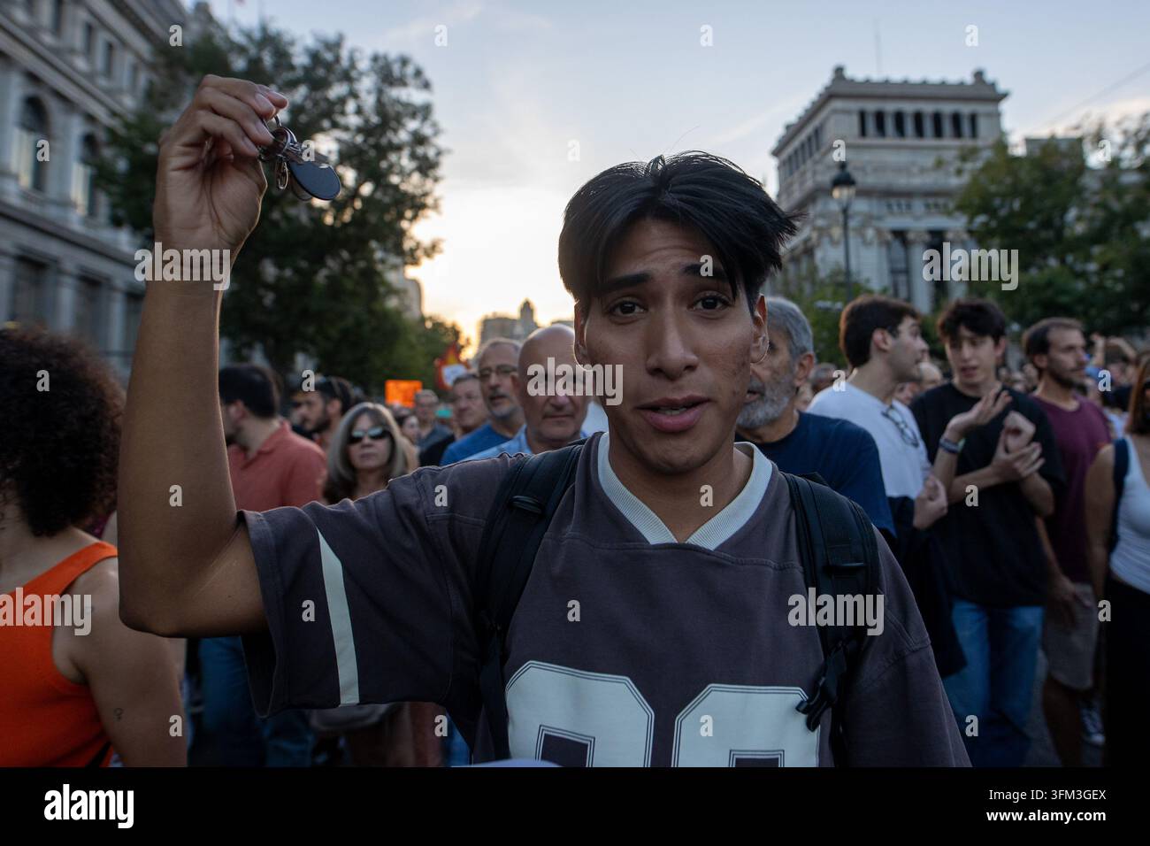 Protesters hold up keys during a housing protest in Madrid. Protest ...
