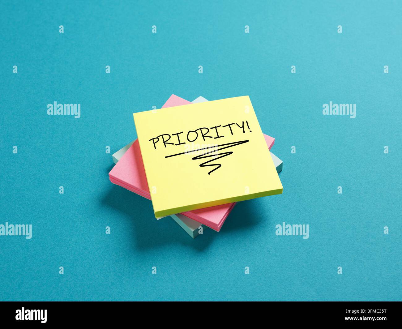 Stack of colorful sticky notes with PRIORITY message, symbolizing urgent tasks, important reminders, and time management Stock Photo