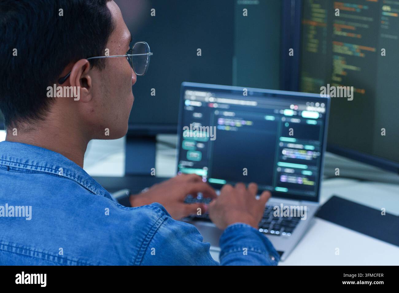 Programmer Coding Software on Laptop Stock Photo