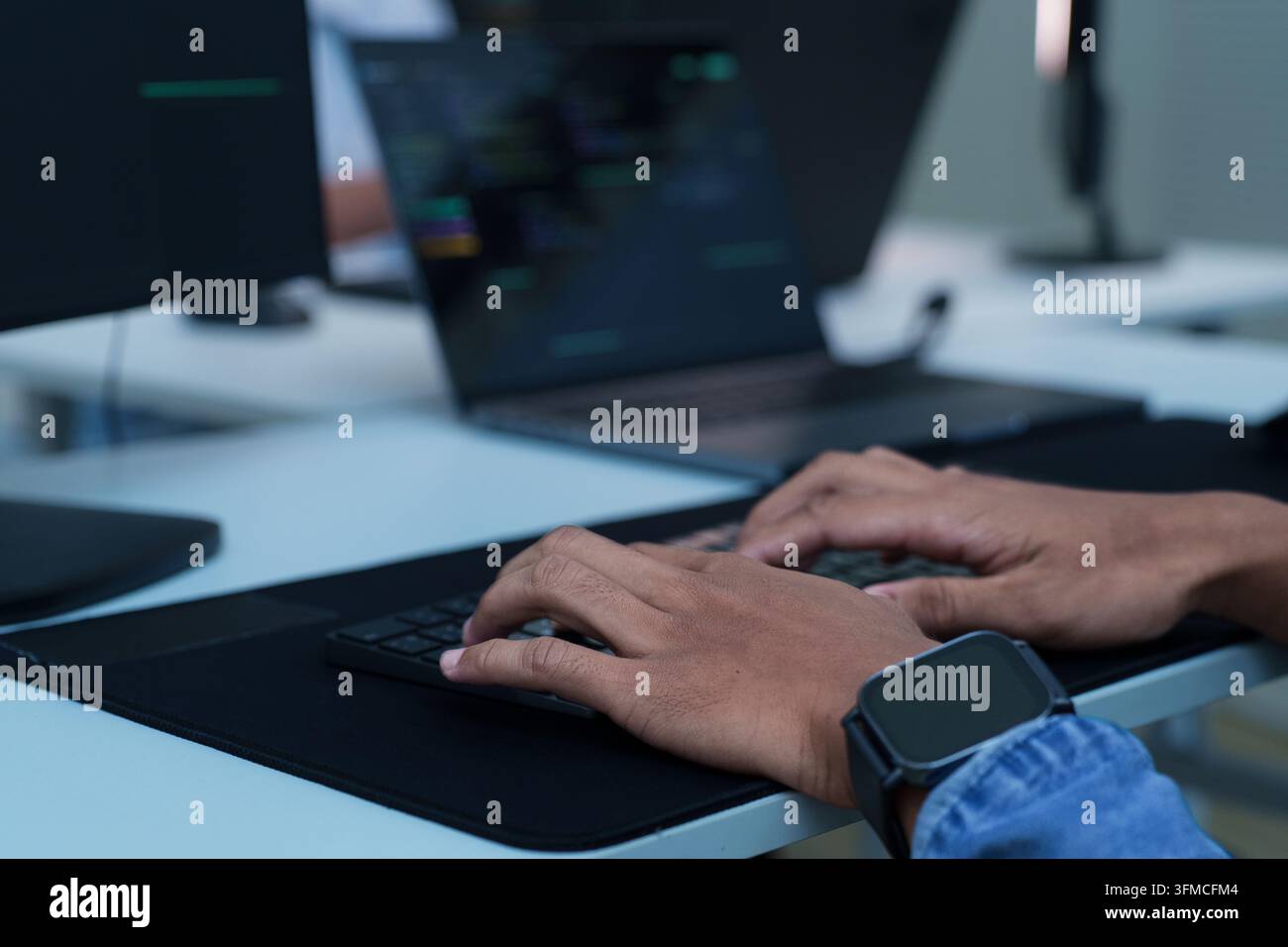 Programmer Typing Code on Laptop Stock Photo