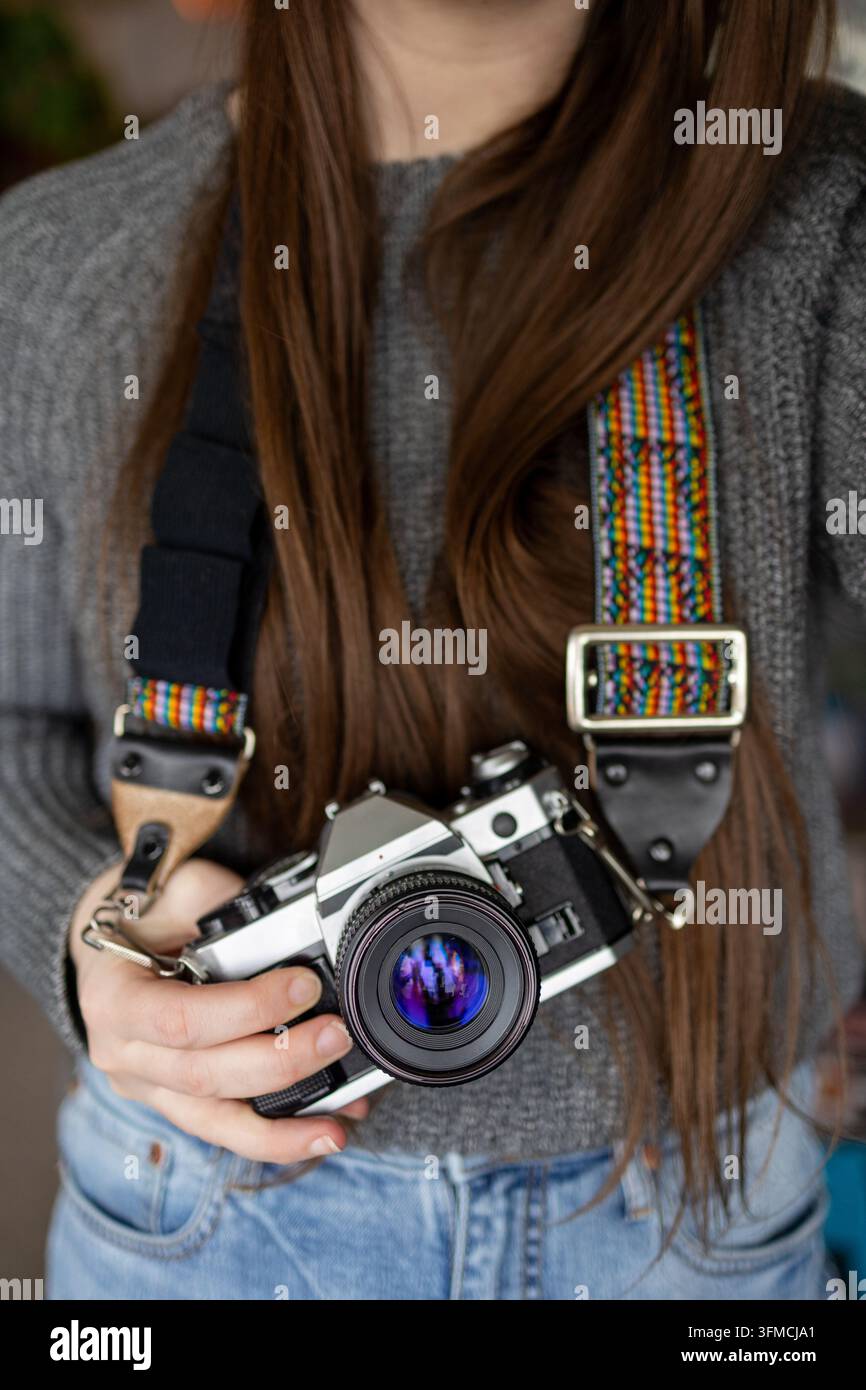 Woman with long hair holding a vintage camera Stock Photo