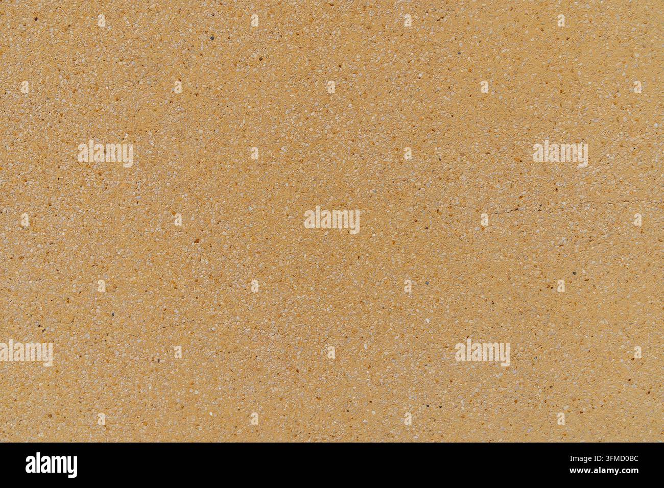 Yellow terrazzo surface with fine natural stone aggregate texture. Stock Photo