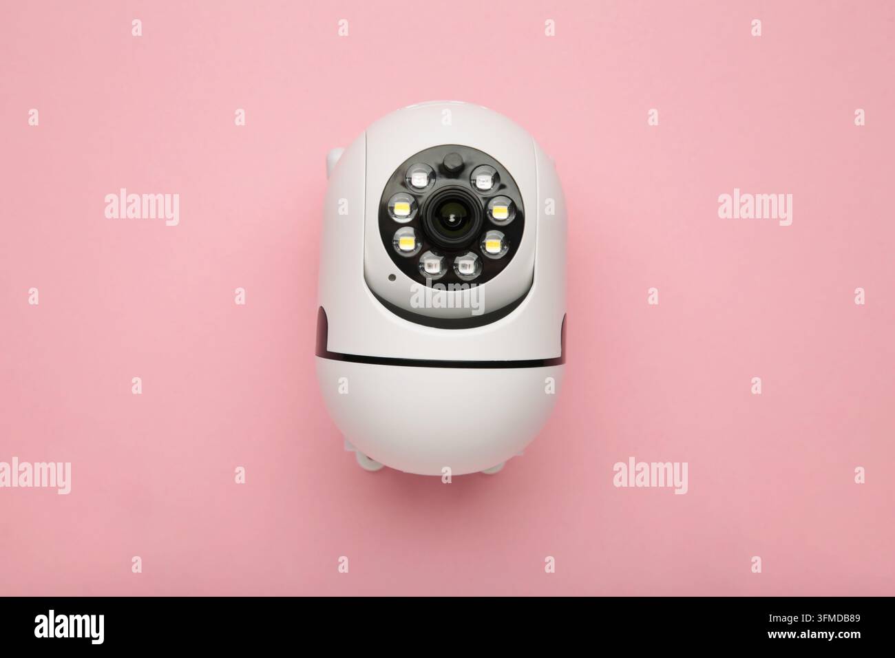 Security camera on pink background. Outdoor surveillance camera. Top view Stock Photo