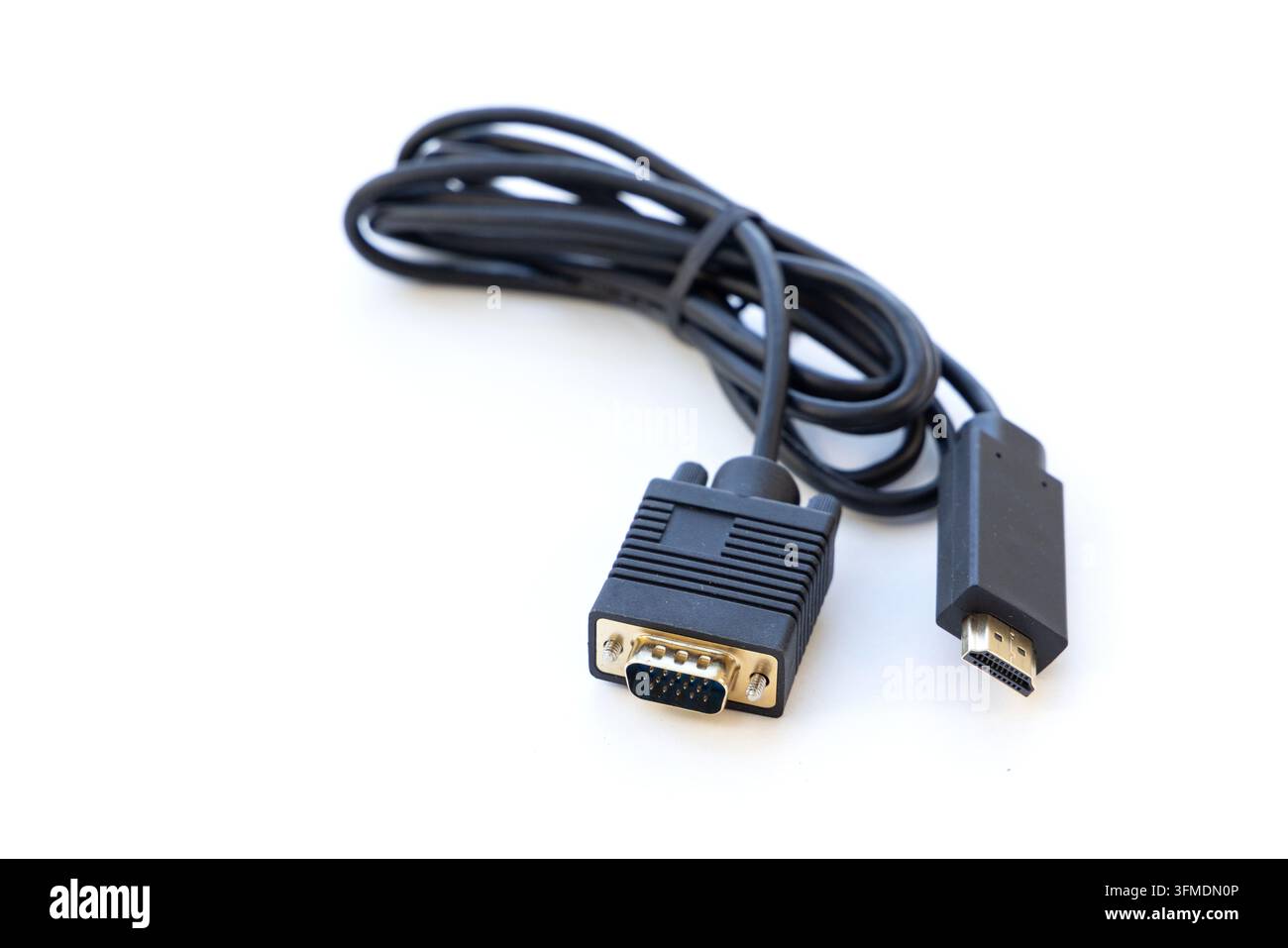 Black converter cable sits coiled on a white surface Stock Photo