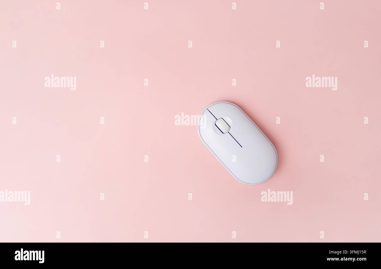 White computer mouse on pink background, top view Stock Photo