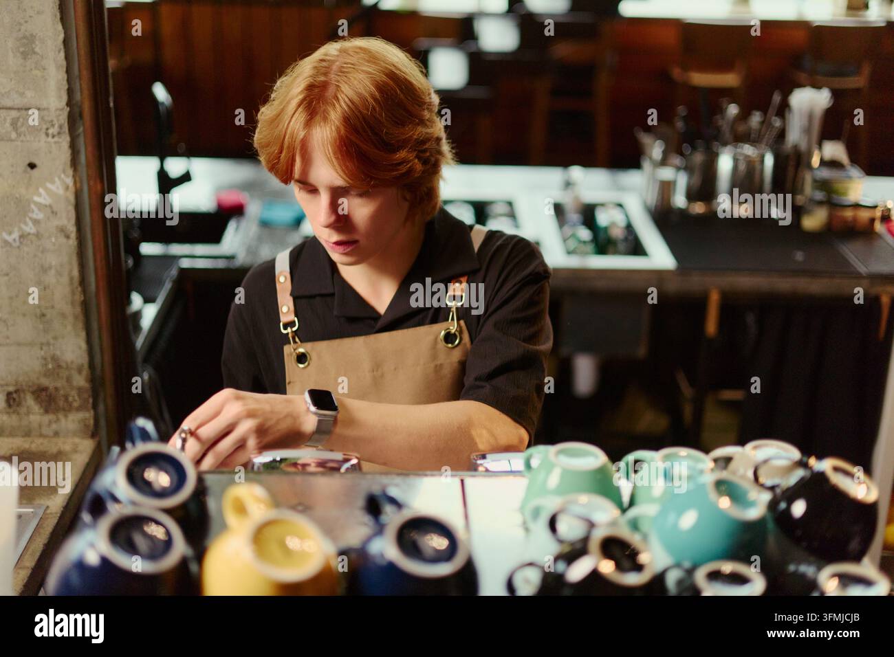 Male Barista Preparing Coffee with Machine in Modern Cafe Stock Photo