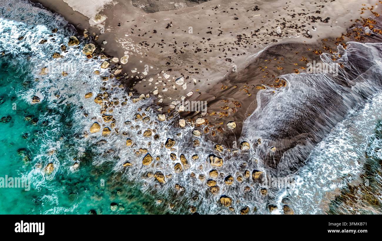 Aerial View Rocks Aerial view of Tapuae Beach featuring dark sand, scattered rocks, and ...