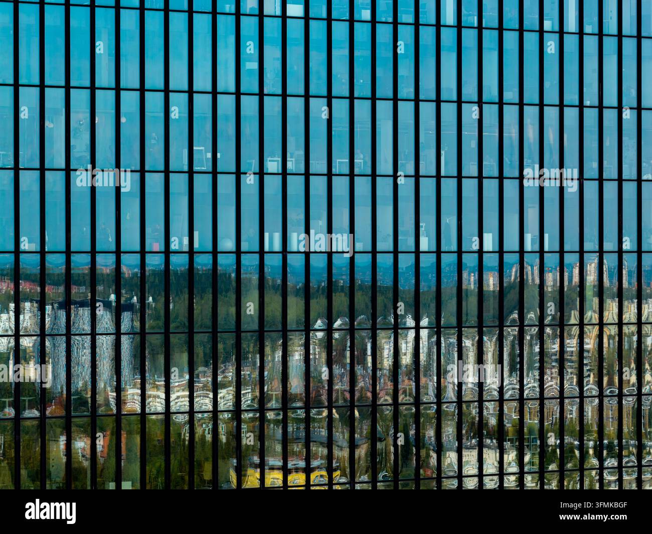 Aerial view of the glass facade of a modern office building reflecting ...