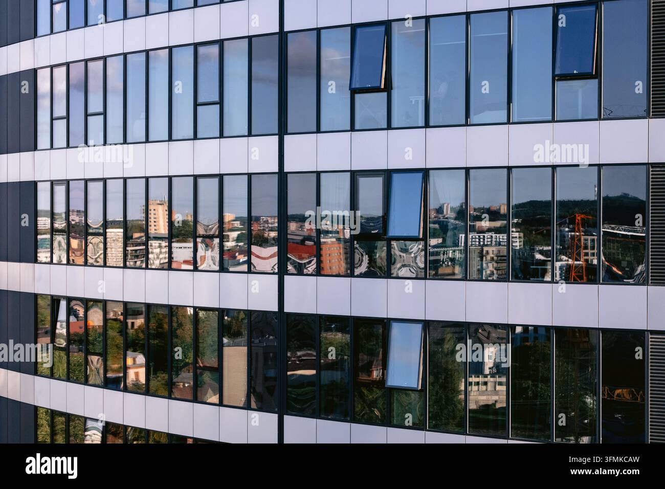 Aerial view of a modern glass building facade reflecting the urban ...
