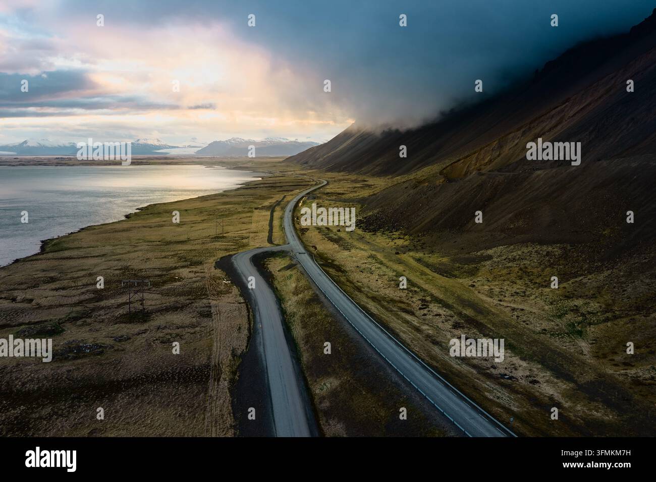 Aerial view of Vestrahorn mountain and the coastal road winding through ...